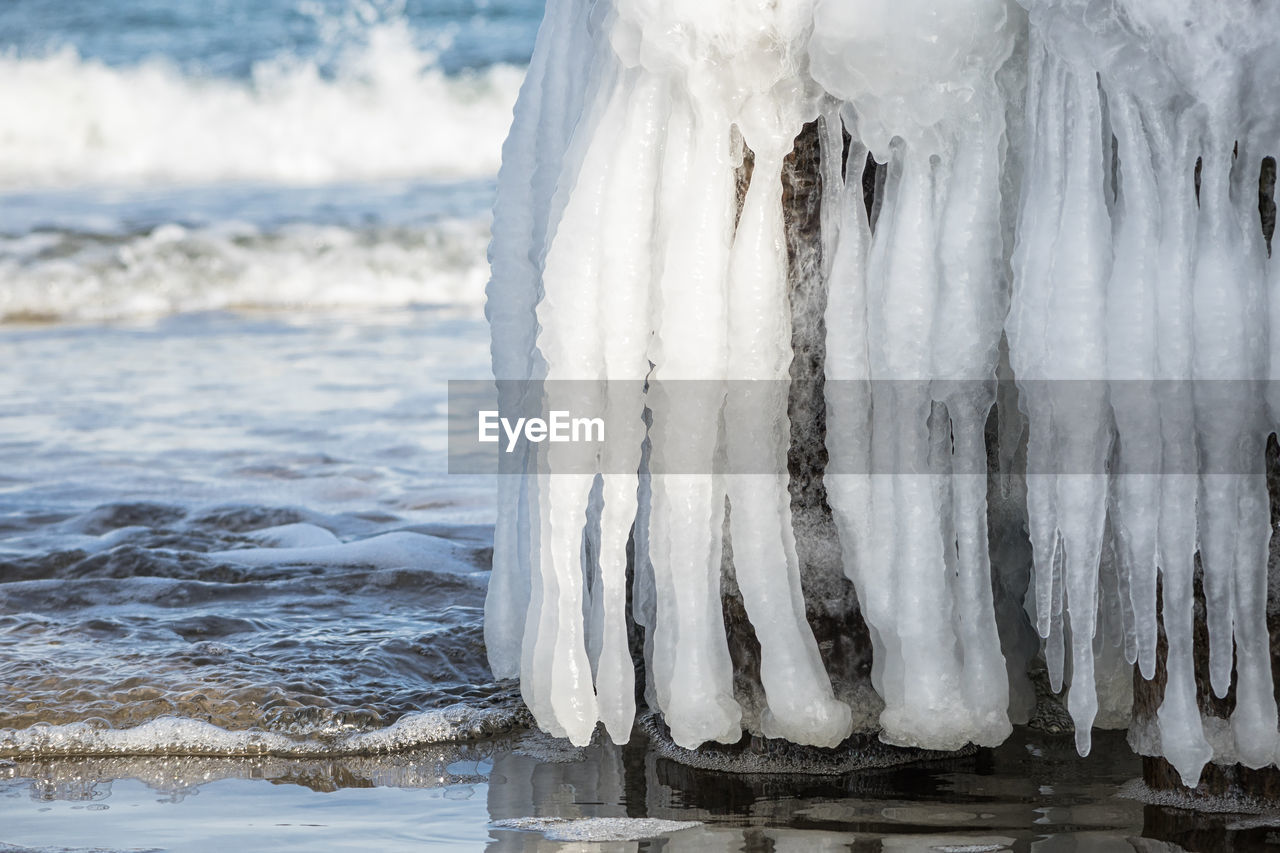 CLOSE-UP OF ICE CRYSTALS ON BEACH