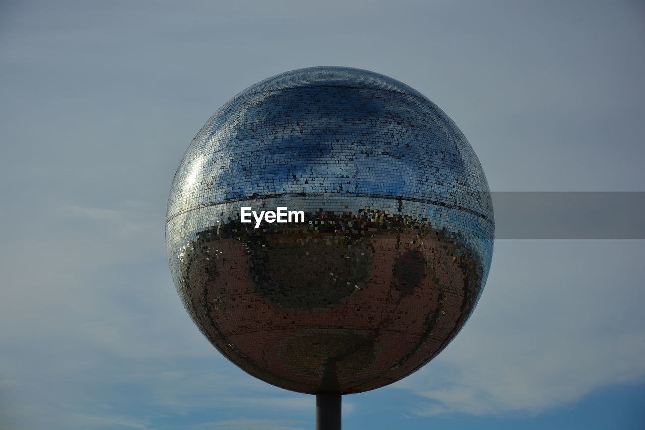 HIGH SECTION OF STREET LIGHT AGAINST SKY