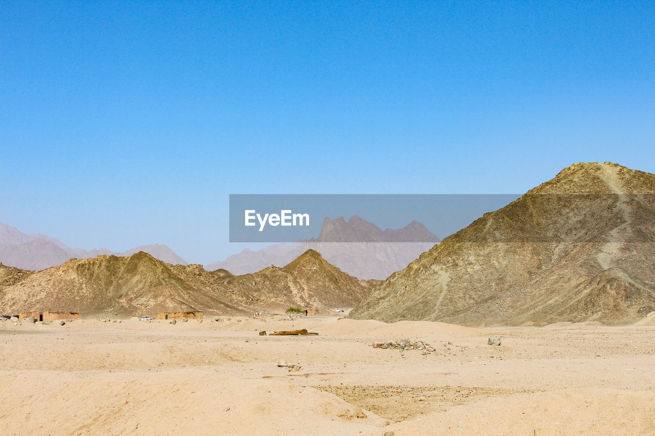 Idyllic shot of mountains in desert against clear blue sky