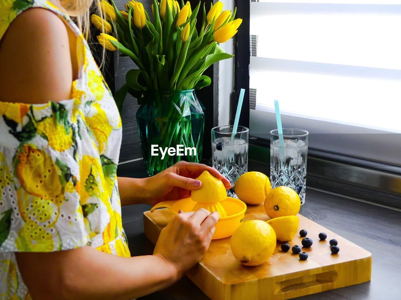 Woman squeezing lemons