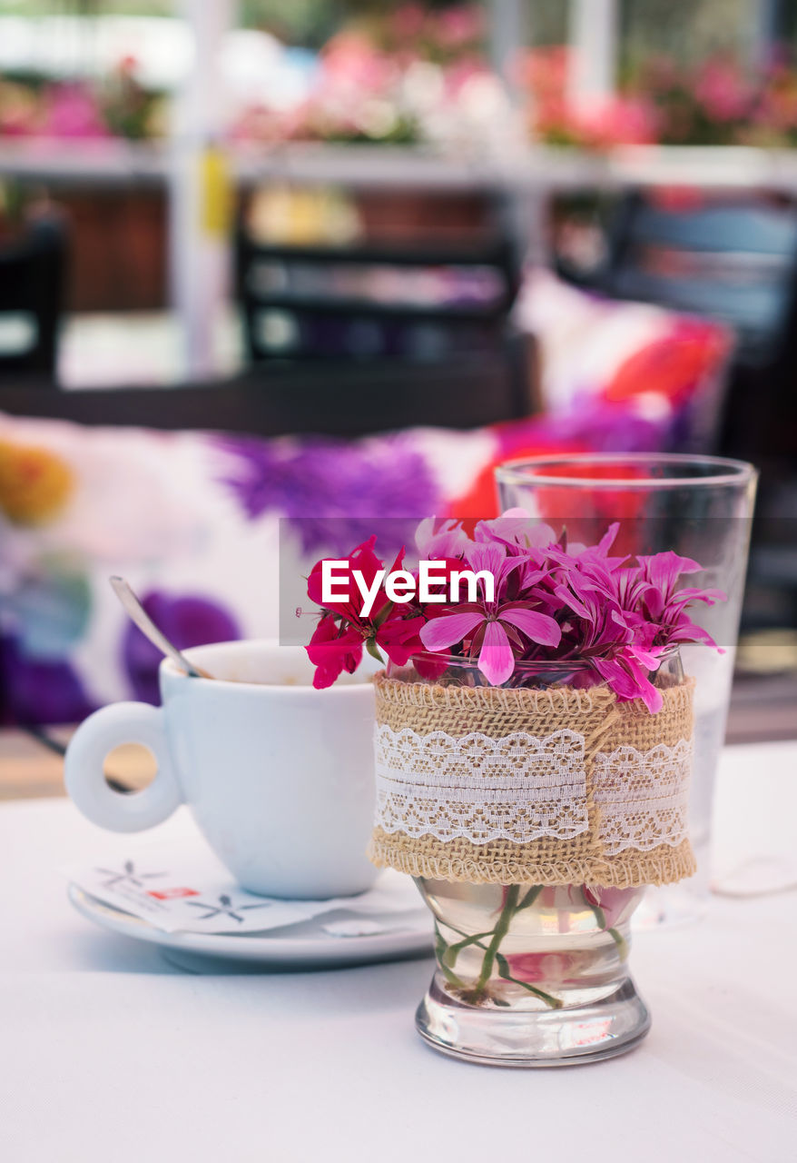 Flowers with coffee cup on table