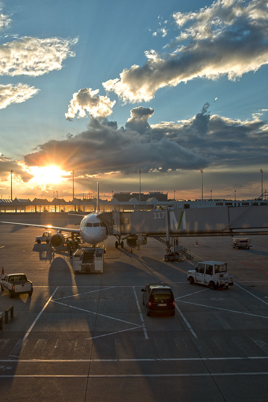 AIRPLANE ON AIRPORT RUNWAY AGAINST SKY