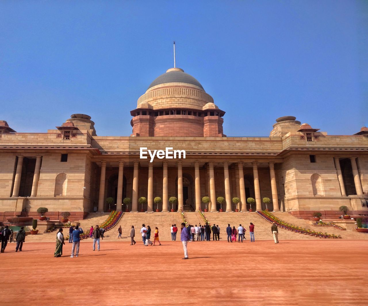 People visiting at rashtrapati bhavan against clear blue sky