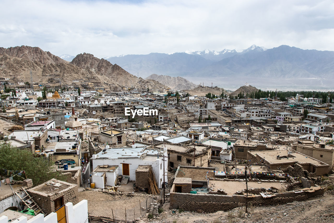 High angle view of townscape and mountains against sky