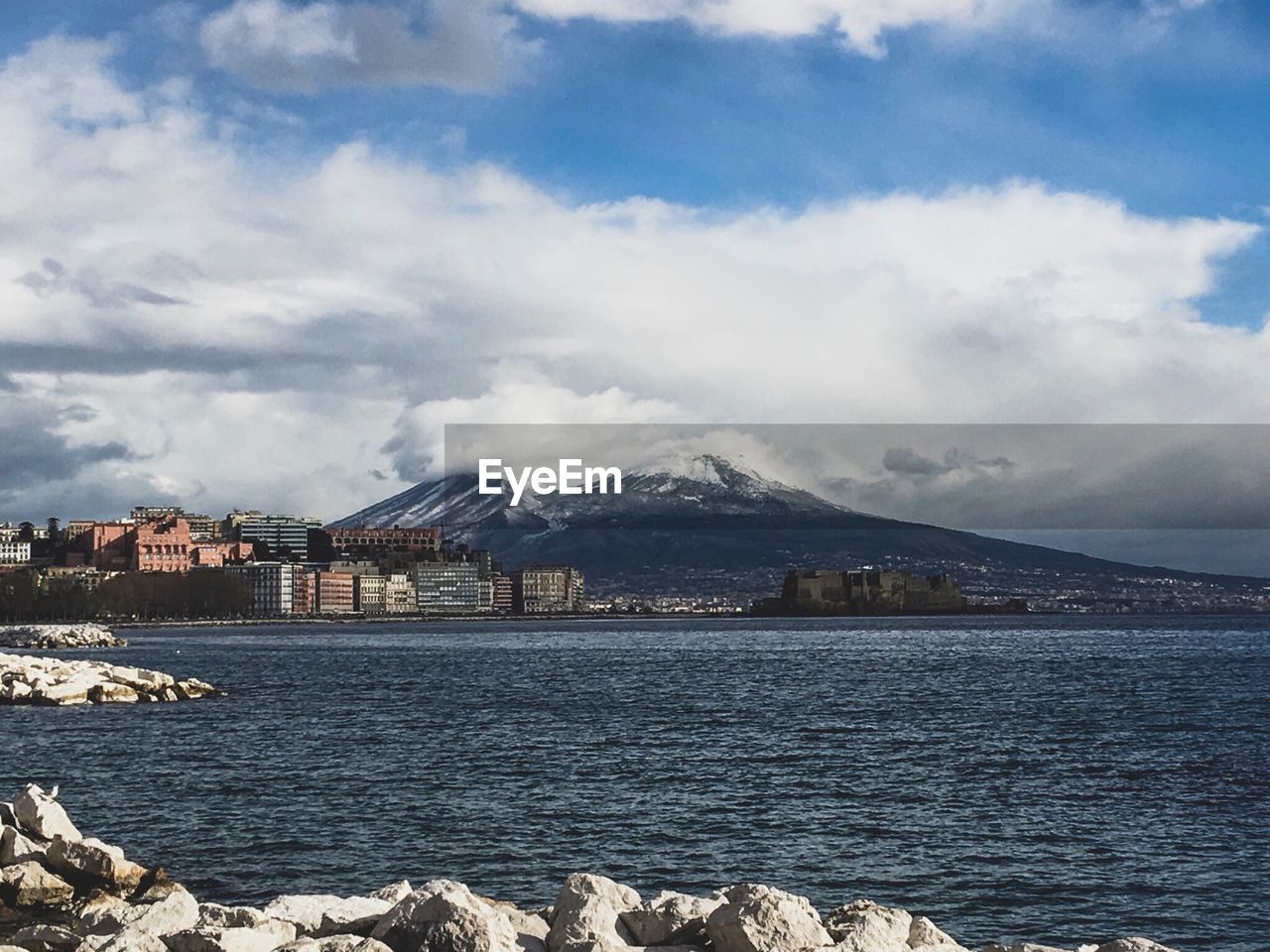 Scenic view of sea and mountains against sky