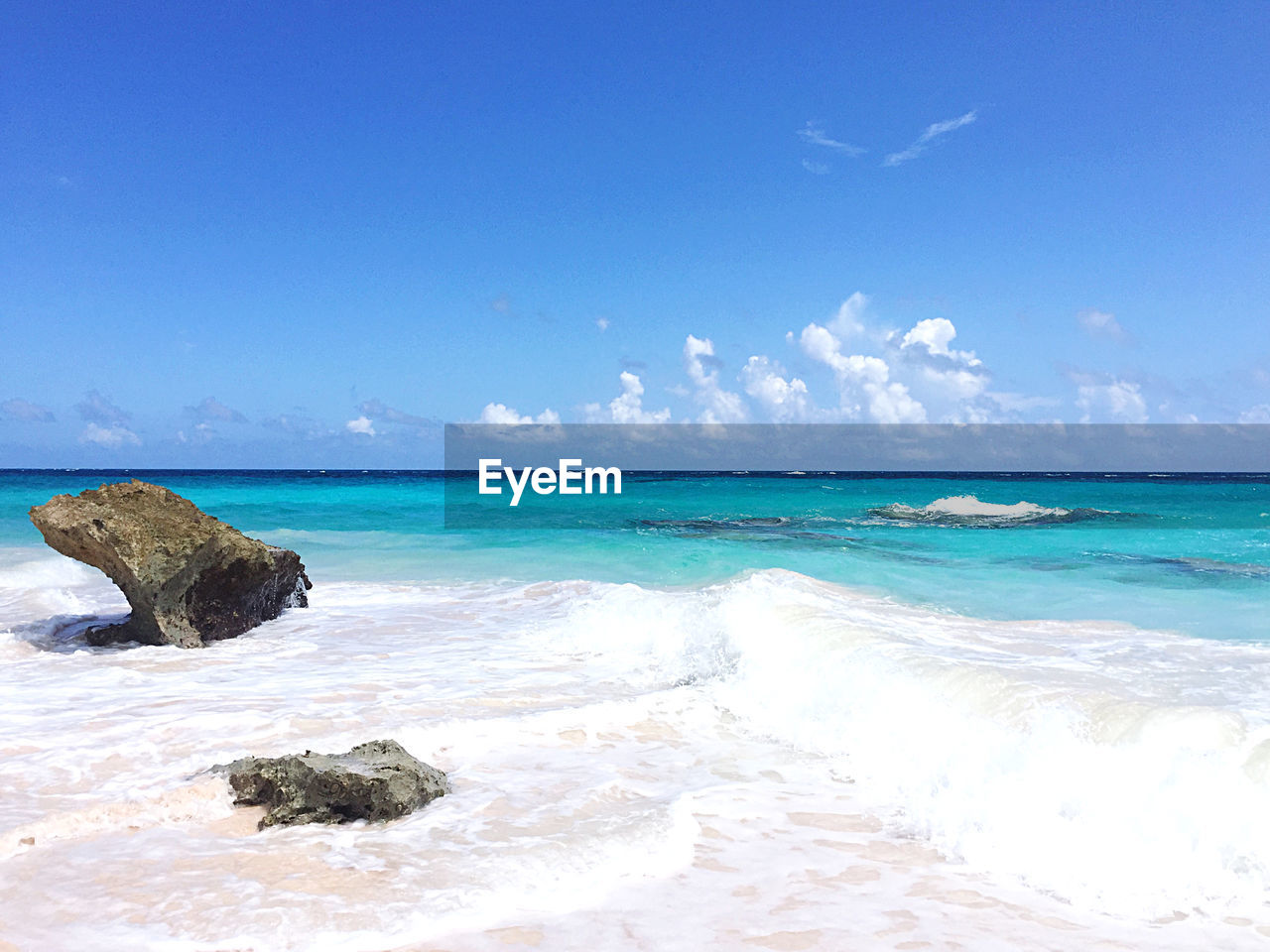 SCENIC VIEW OF BEACH AGAINST BLUE SKY