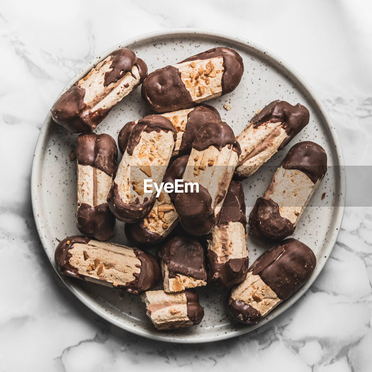 High angle view of bokkenpootjes dutch chocolate cookies against white background