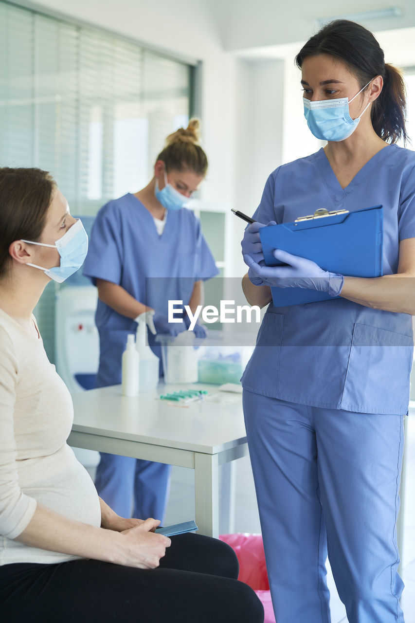 Female doctor examining patient at clinic