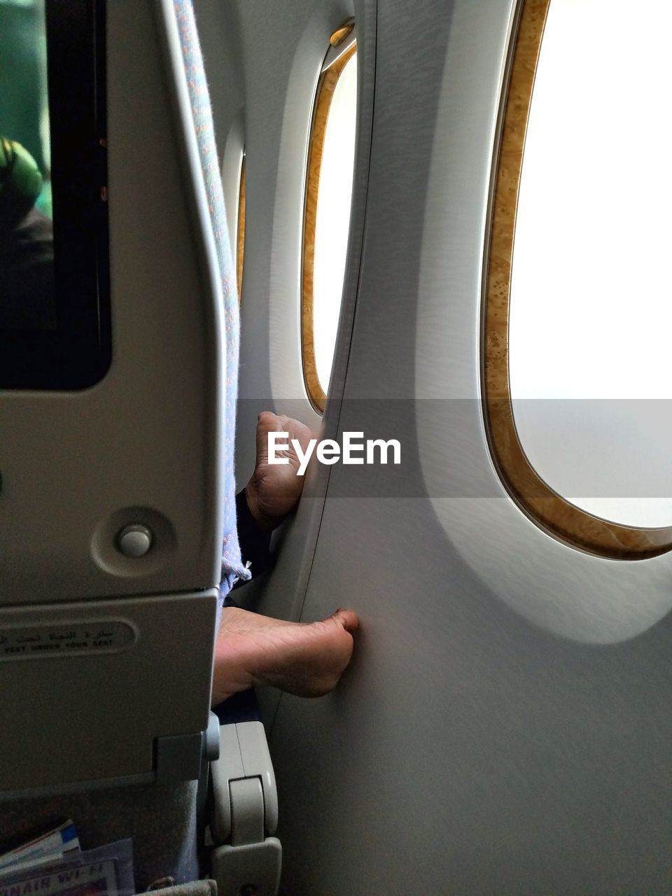 Low section of person in airplane