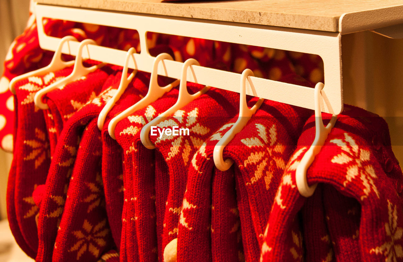 CLOSE-UP OF RED CLOTHES HANGING IN KITCHEN