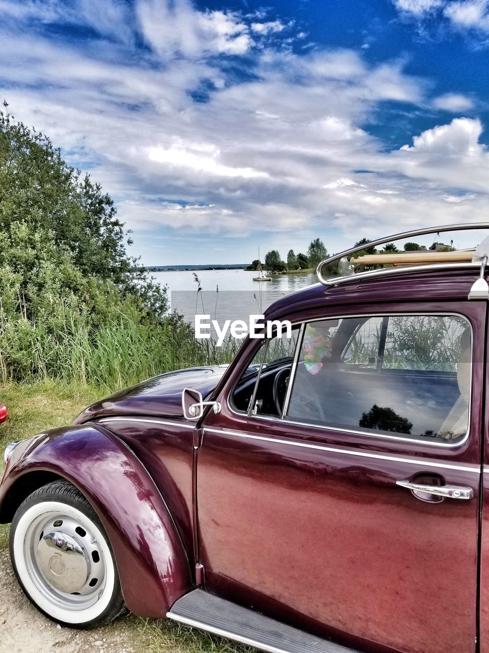 CAR PARKED AGAINST SKY