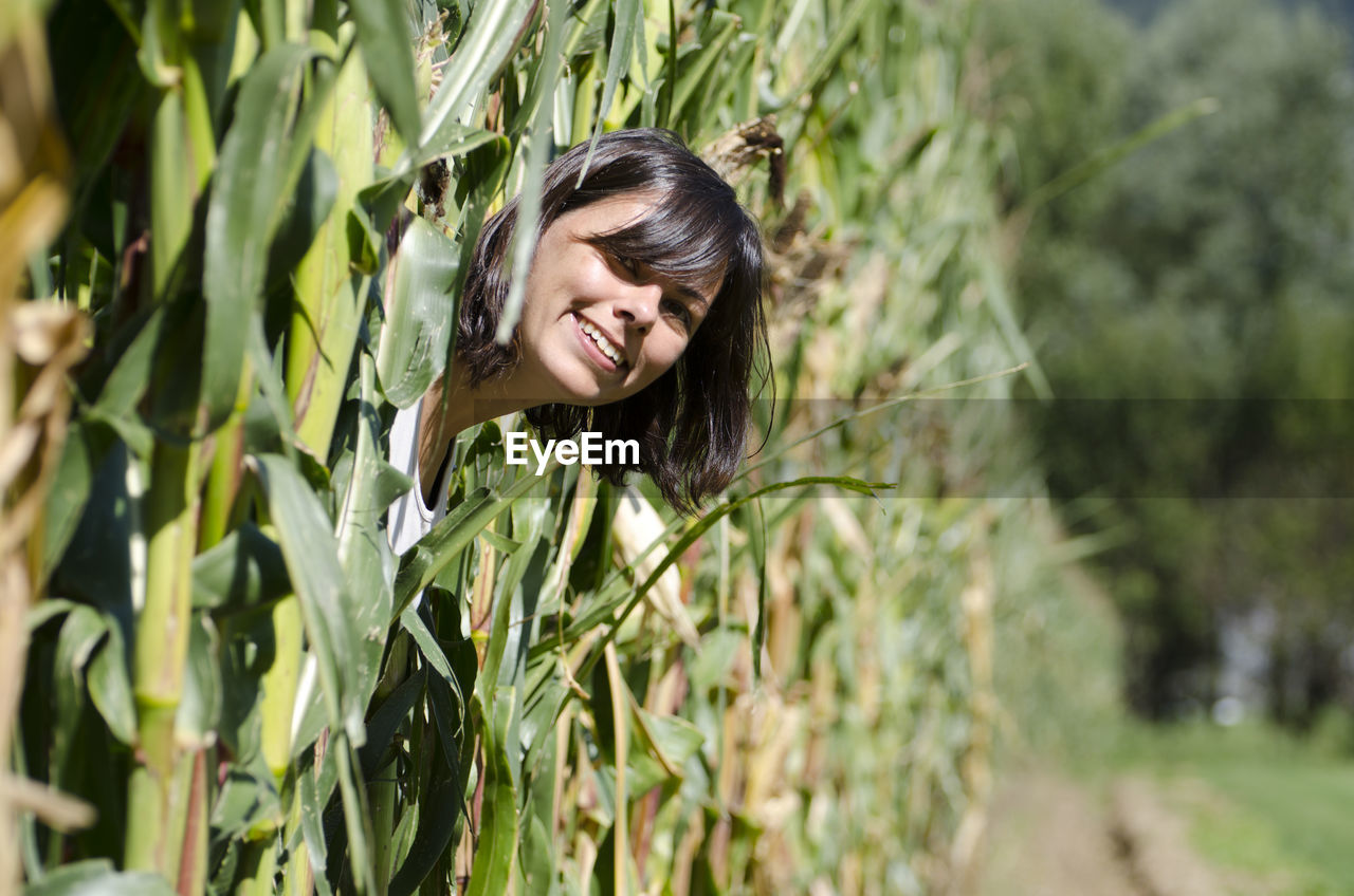 Close-up portrait of young woman in field