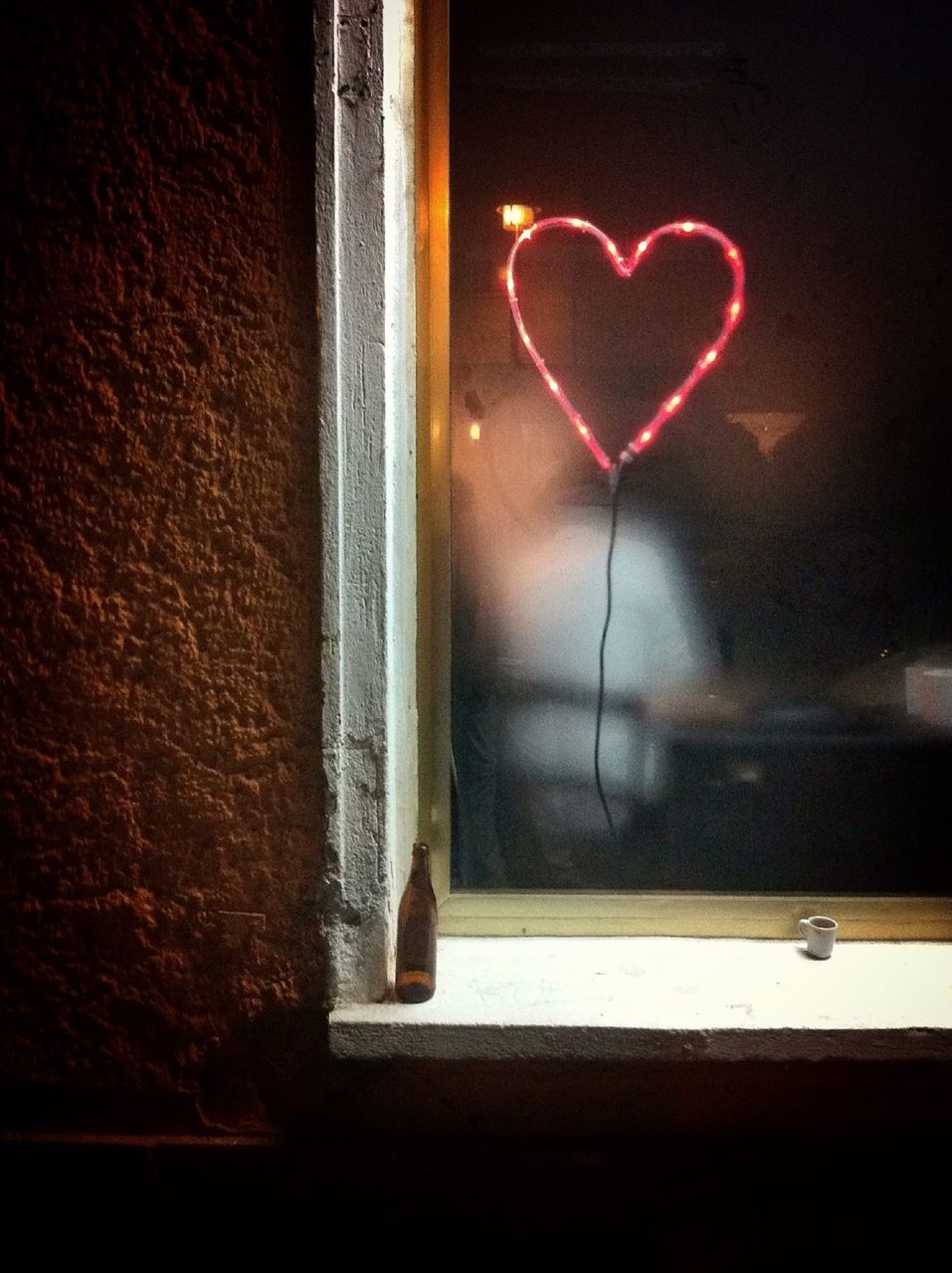 Heart shape made from electric light on window