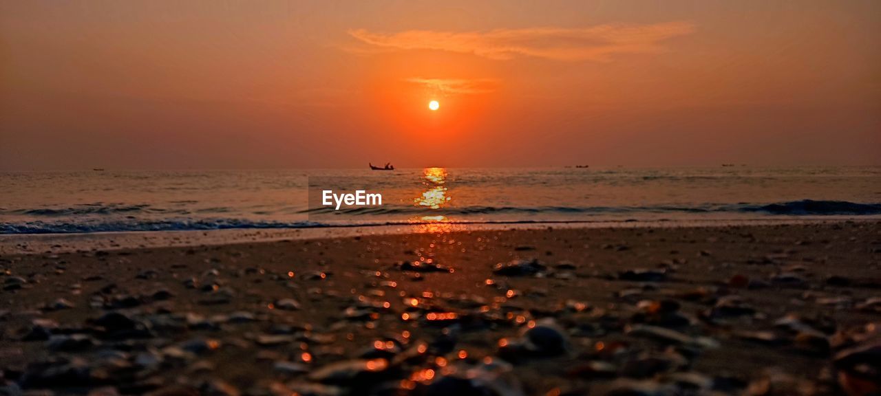 sky, sea, water, sunset, land, beach, beauty in nature, nature, scenics - nature, horizon over water, horizon, orange color, sun, tranquility, environment, tranquil scene, ocean, wave, sand, cloud, reflection, shore, seascape, landscape, travel destinations, dramatic sky, travel, dawn, motion, sunlight, idyllic, evening, coast, outdoors, urban skyline, no people, vacation, trip, water's edge, holiday, tide, coastline, tourism, afterglow, non-urban scene, romantic sky, atmospheric mood, summer, silhouette, low tide