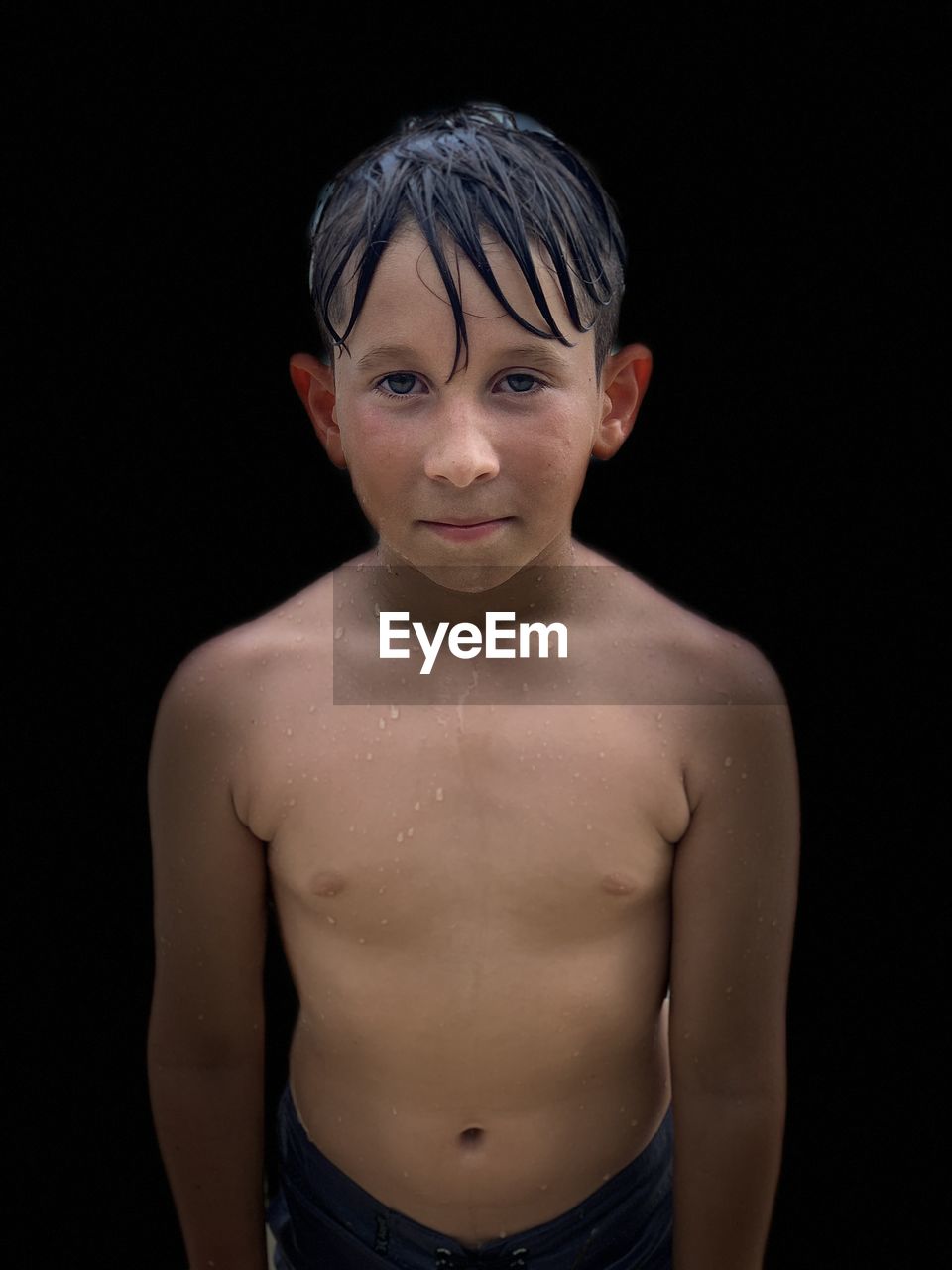 PORTRAIT OF SHIRTLESS BOY AGAINST GRAY BACKGROUND