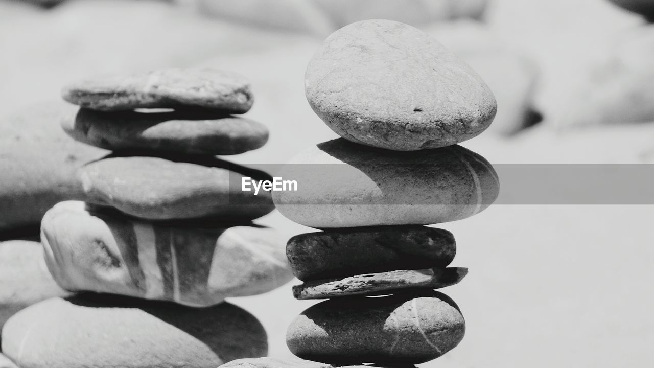 Close-up of stacked pebbles on sunny day