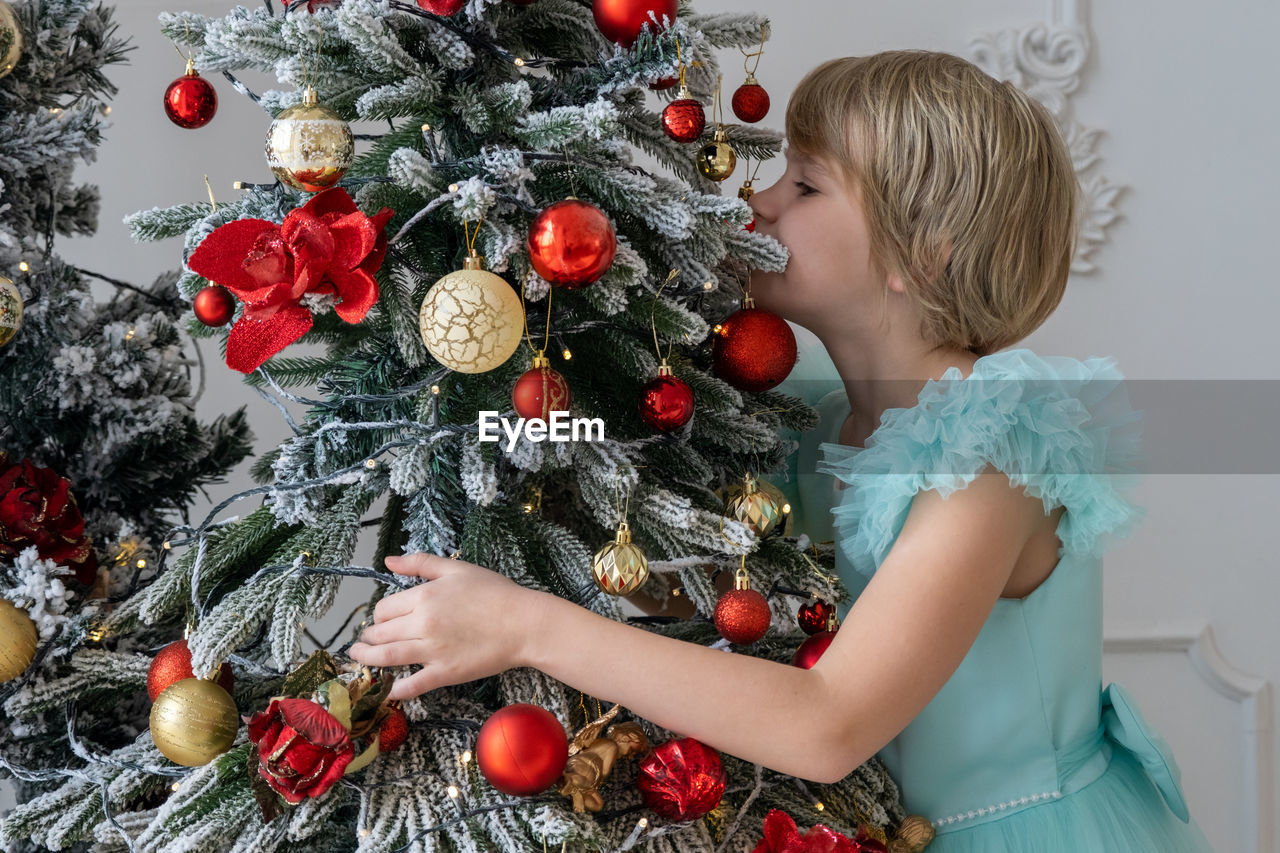 portrait of woman decorating christmas tree