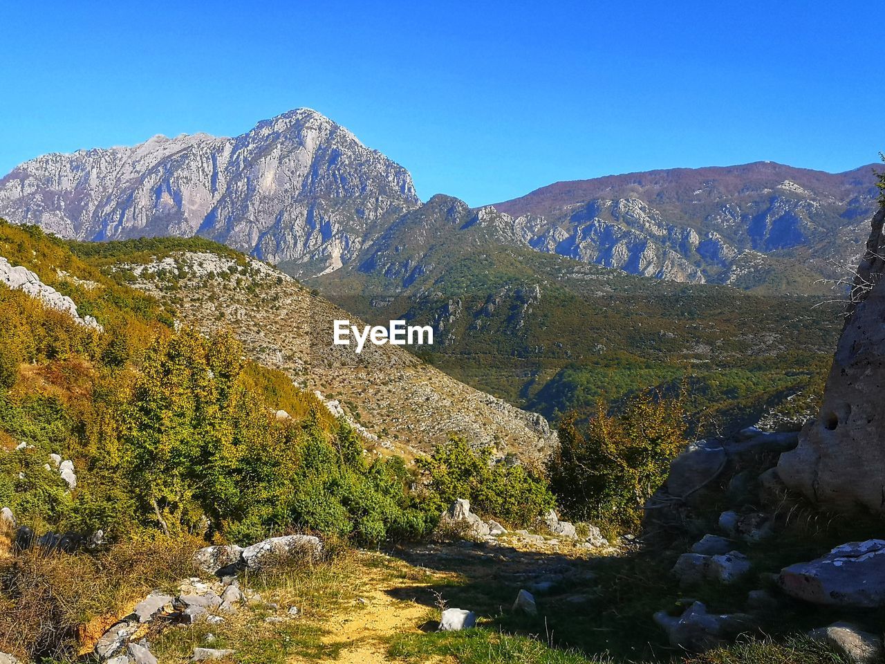 Scenic view of mountains against clear blue sky