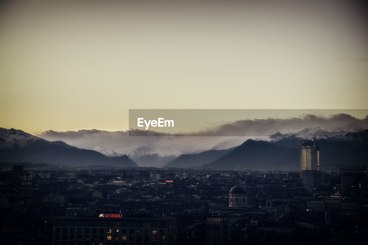 Smoke emitting from turin against sky in city