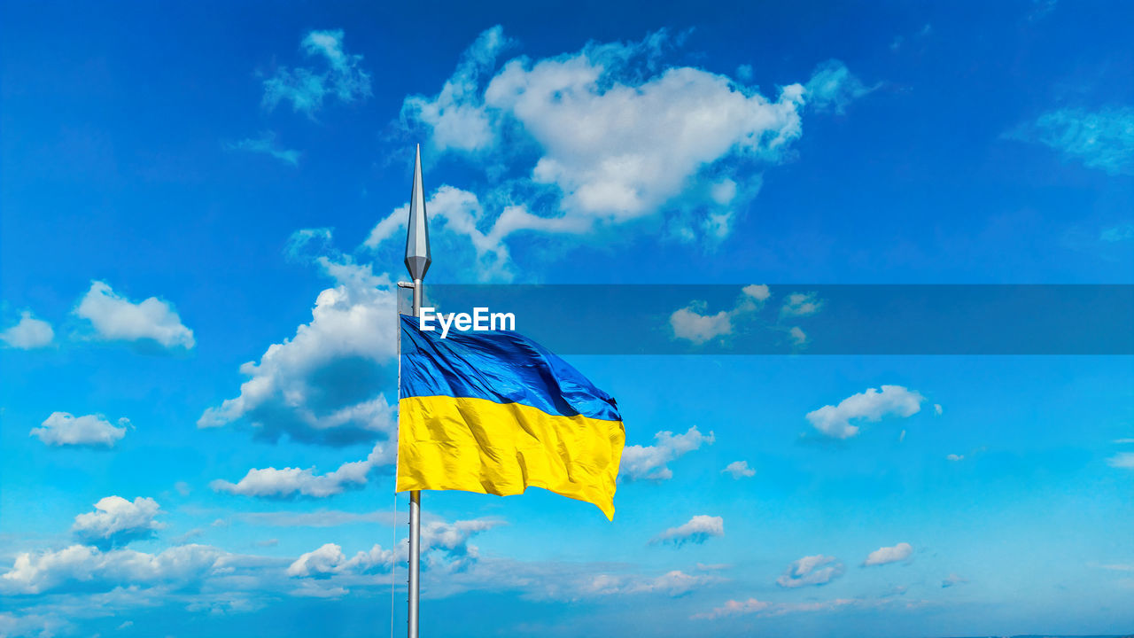 Ukraine flag national symbol waving on blue sky background