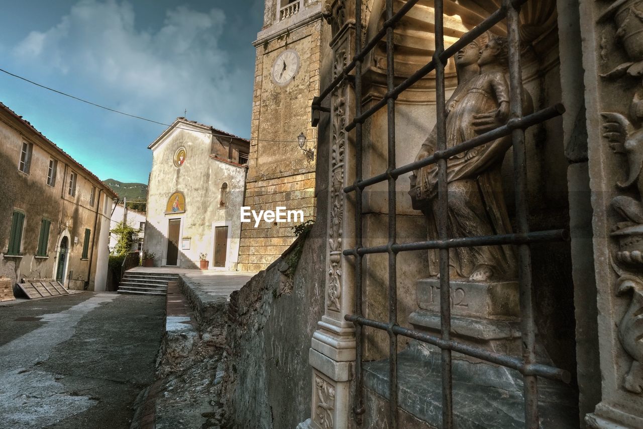 Low angle view of old building against sky in city