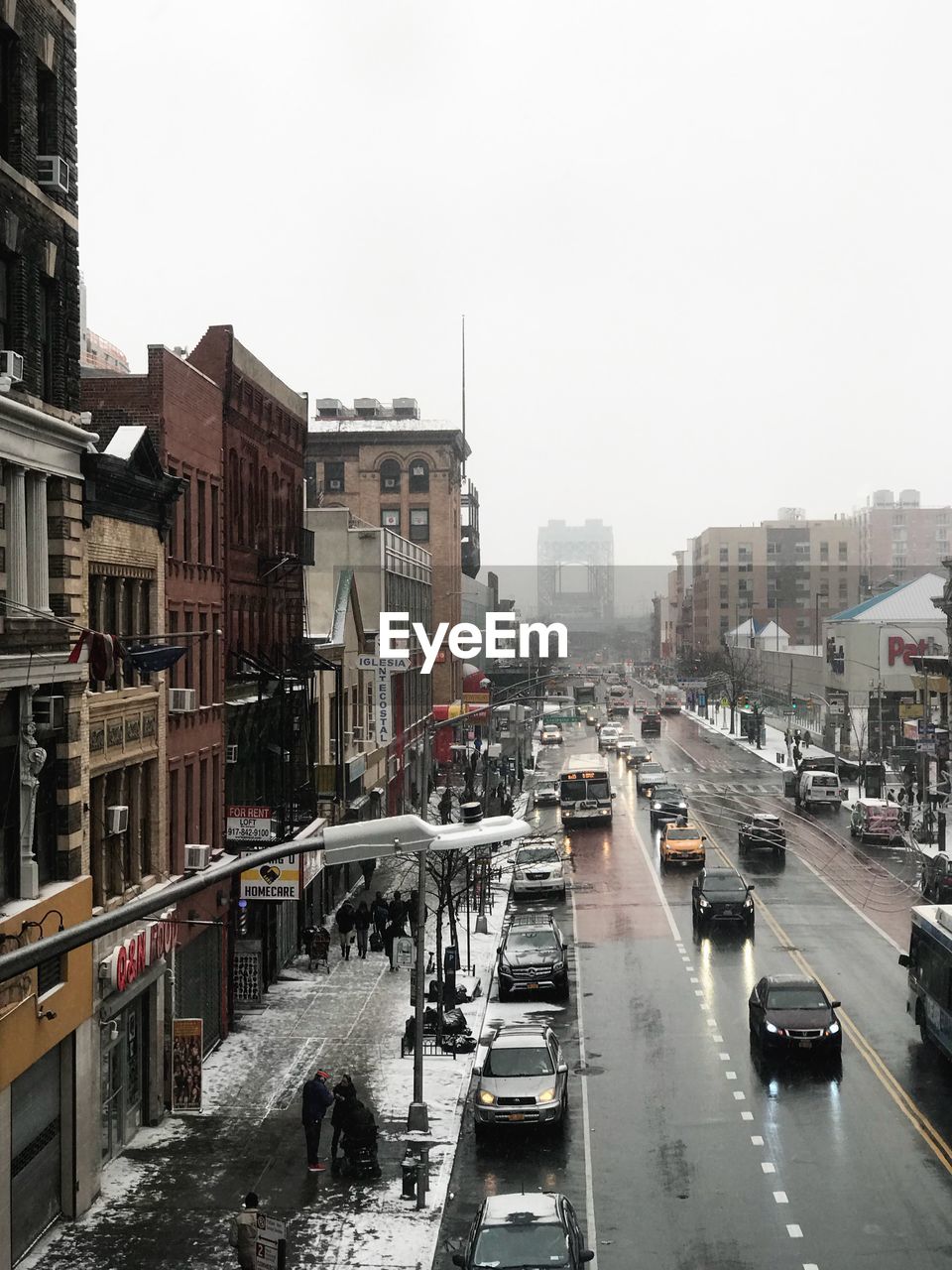 Vehicles on road in city against clear sky