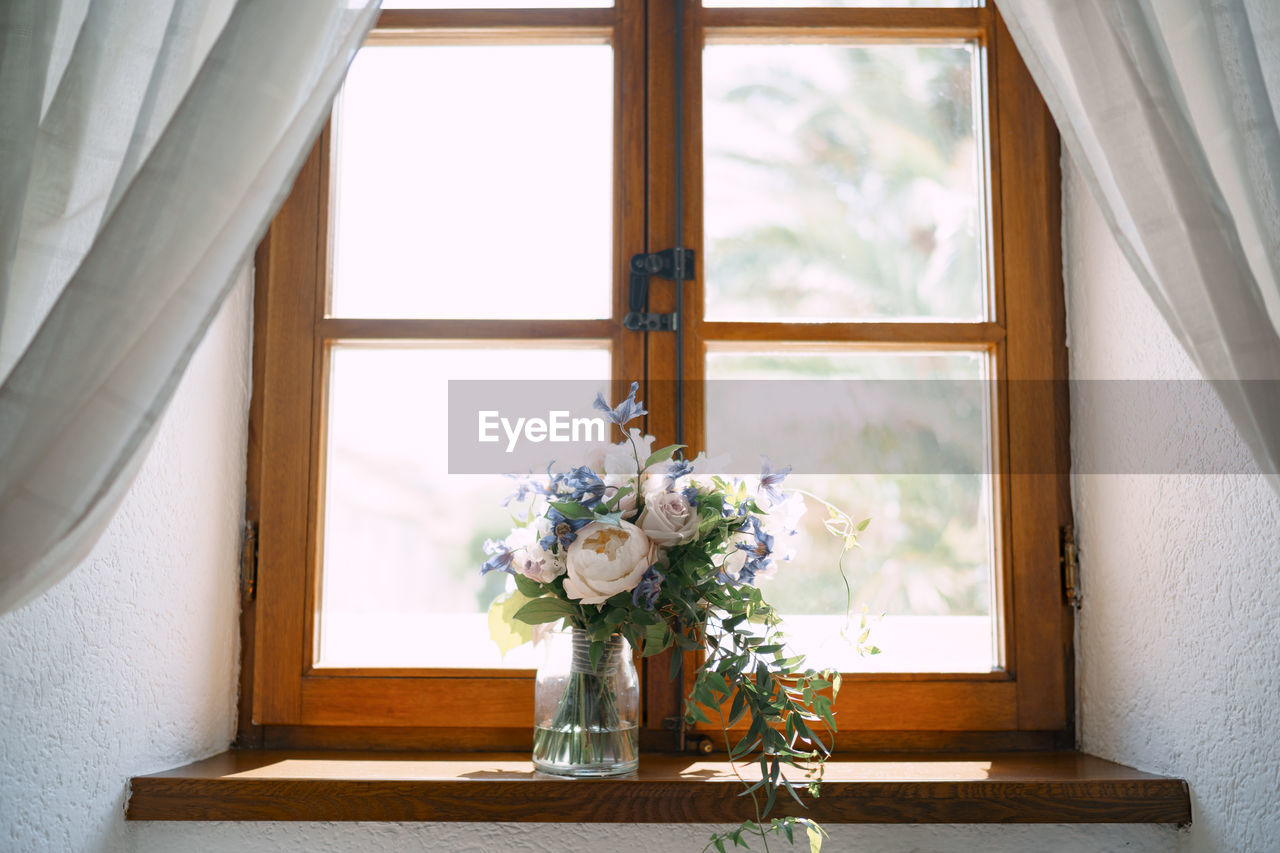 FLOWER VASE ON WINDOW SILL OF HOME