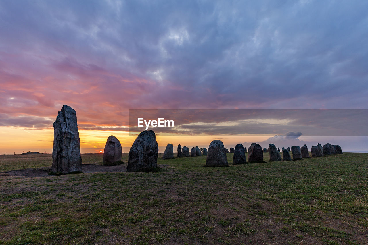PANORAMIC VIEW OF ROCKS ON FIELD AGAINST SKY
