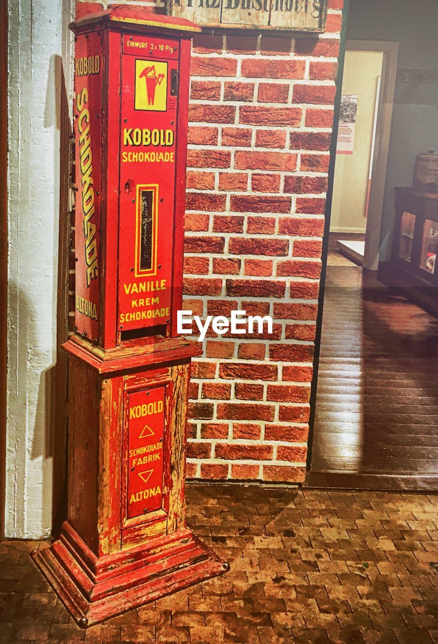 RED SIGN ON BRICK WALL