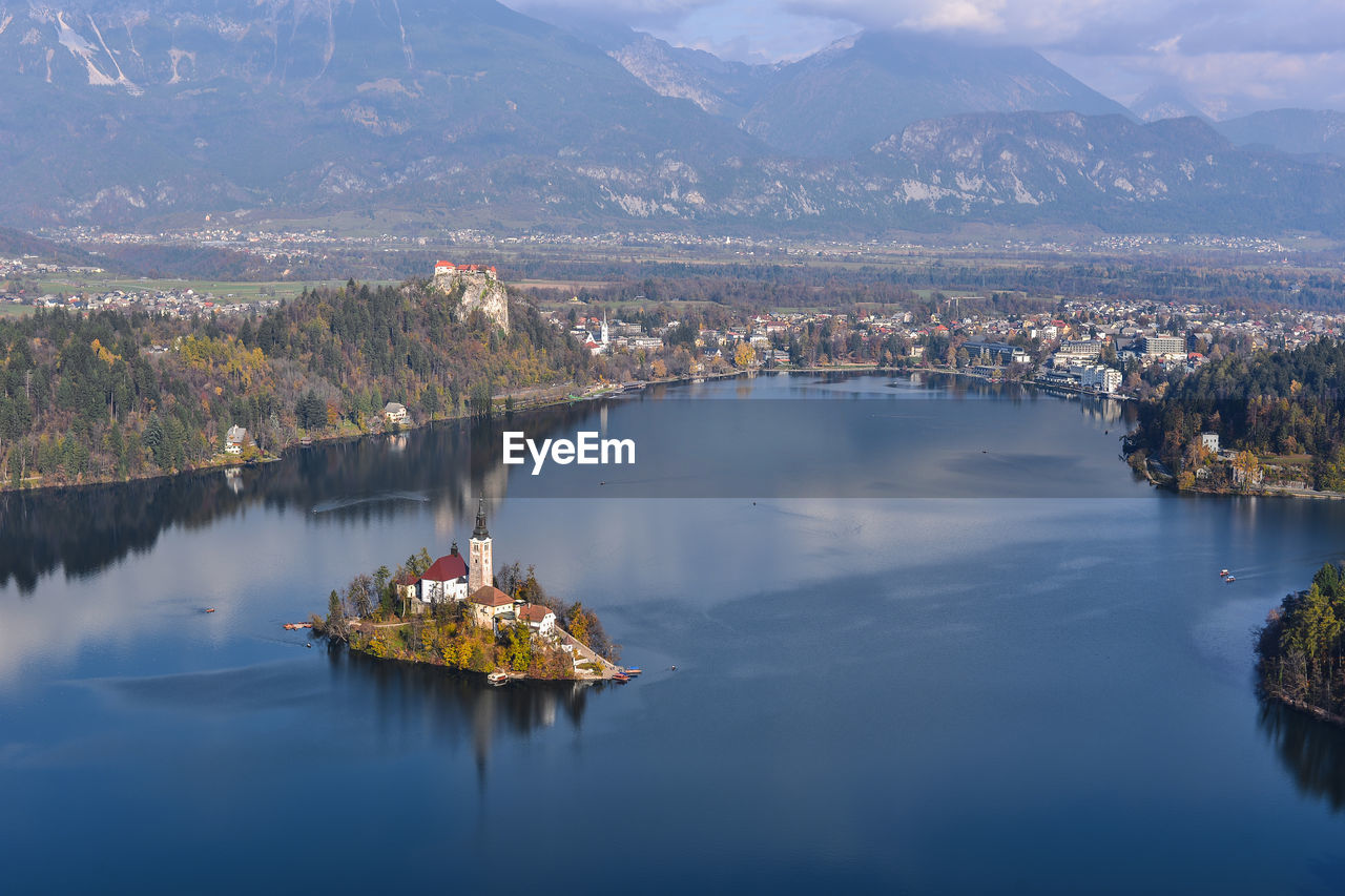 High angle view of lake by mountain against sky