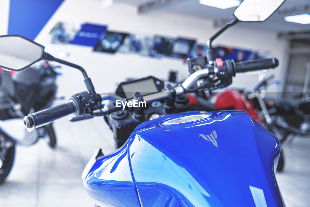 CLOSE-UP OF BICYCLE PARKED AGAINST BLUE WALL