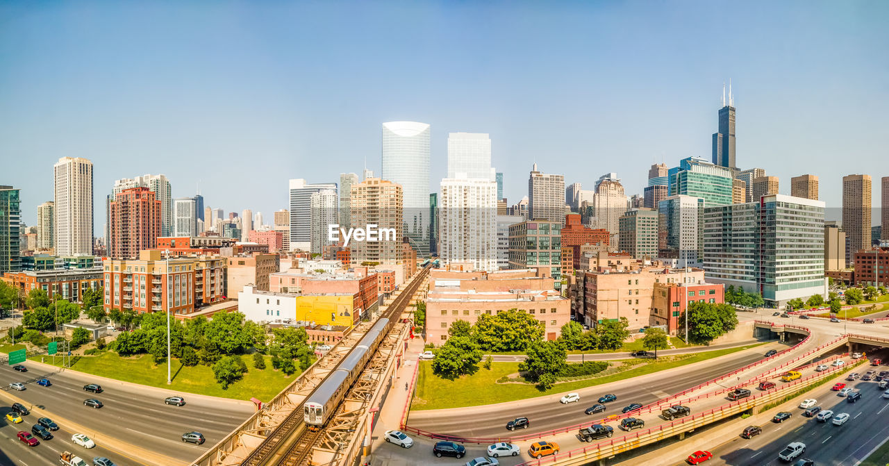 Aerial view of city street and buildings against sky