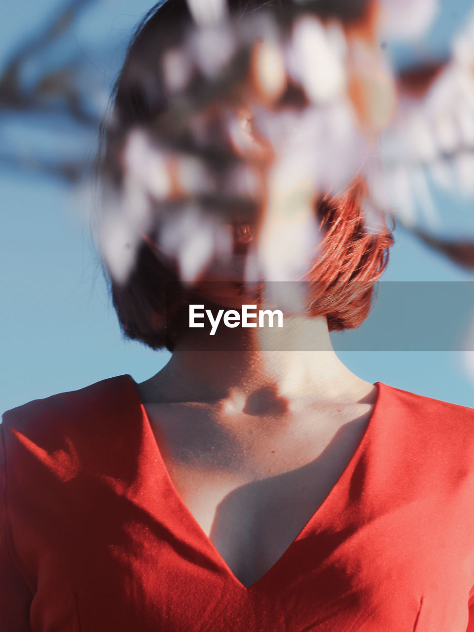 Close-up of beautiful young woman against sky