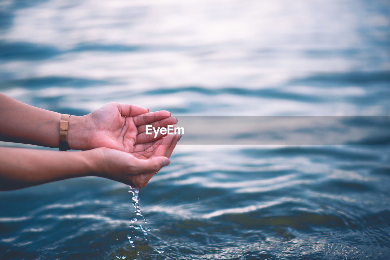 PERSON HAND IN SEA WATER