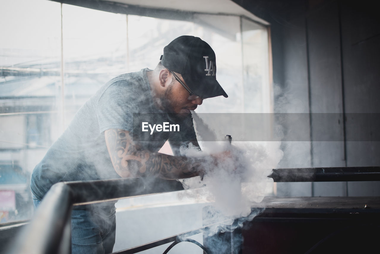 CLOSE-UP OF MAN COOKING