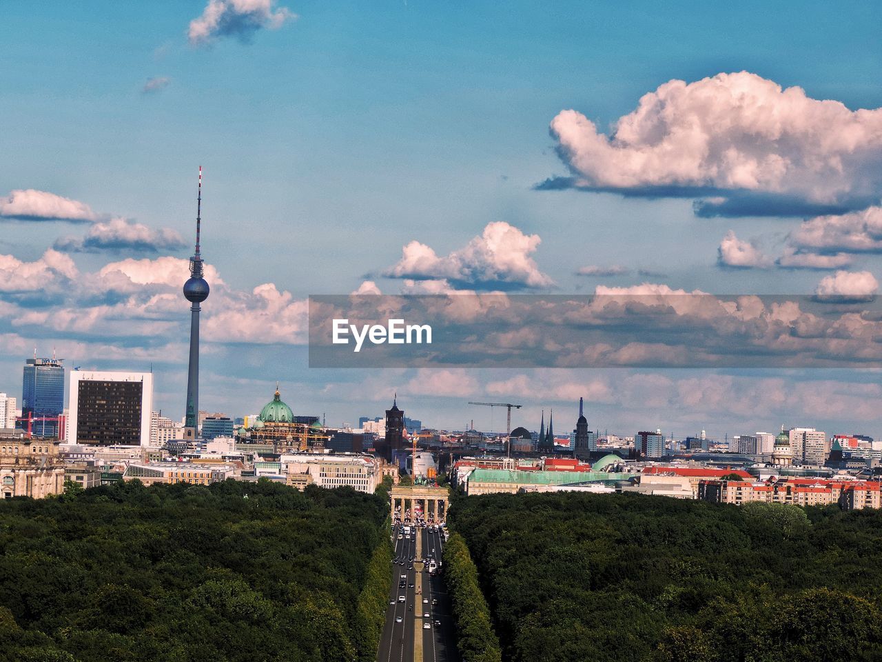 High angle view of buildings in city against cloudy sky