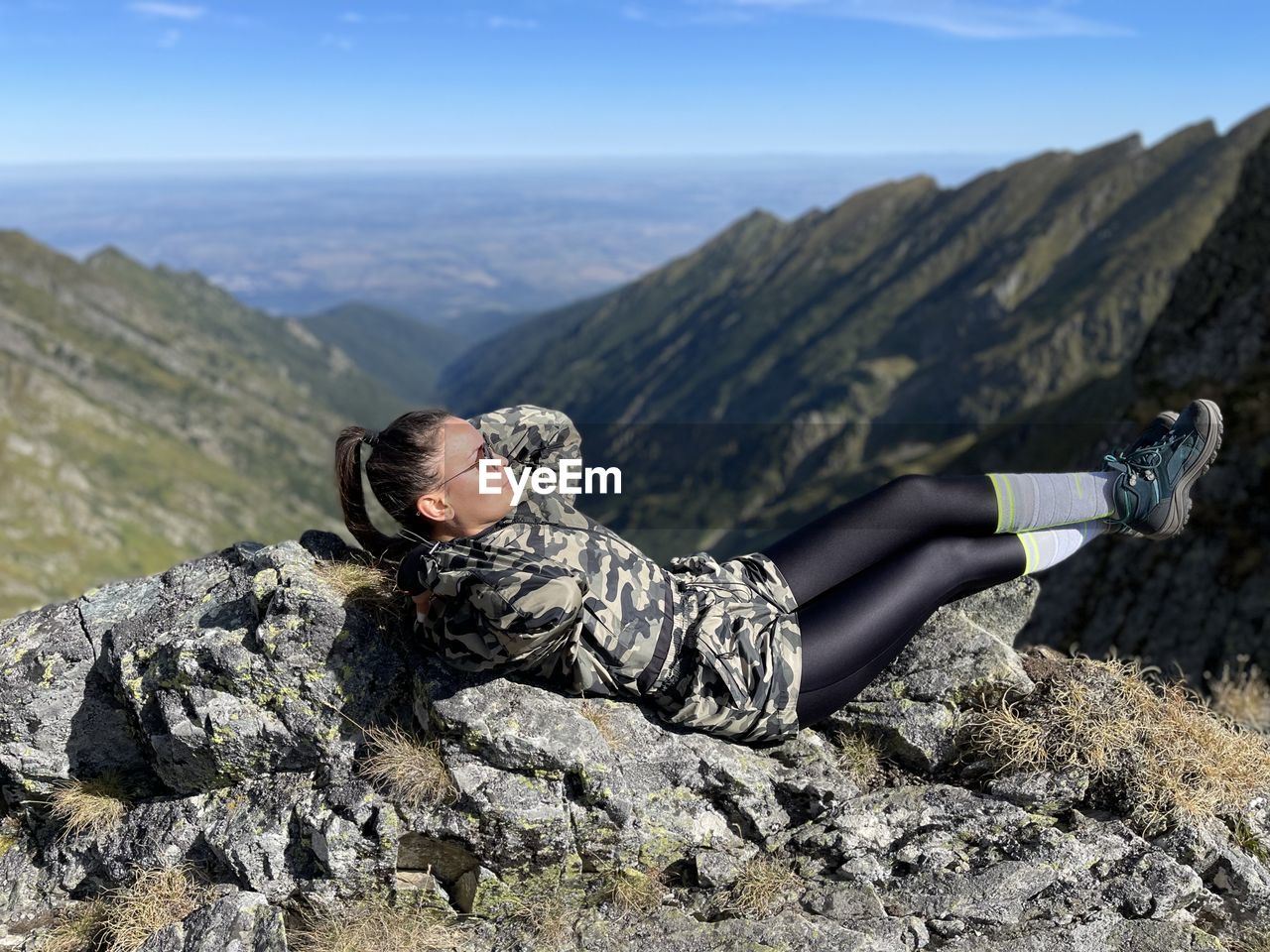low angle view of man sitting on rock
