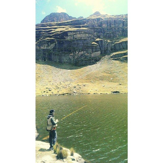 WOMAN STANDING ON MOUNTAIN