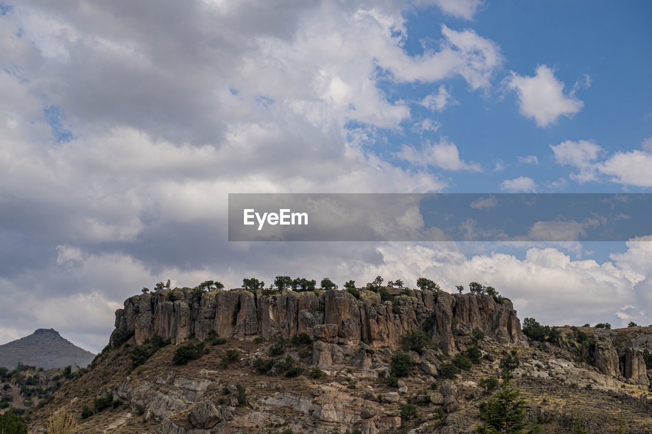 PANORAMIC VIEW OF ROCKS ON MOUNTAIN AGAINST SKY