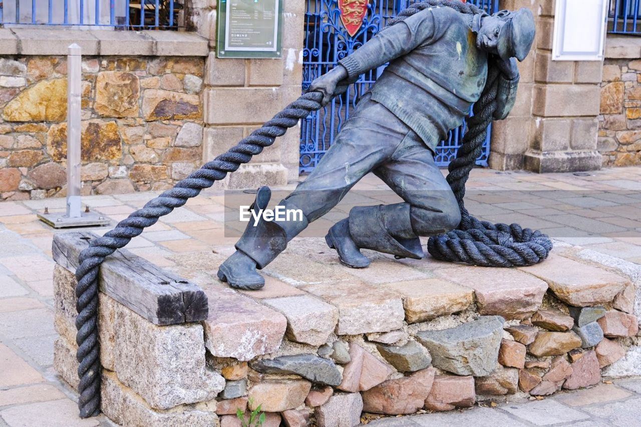 LOW SECTION OF MAN WORKING ON STREET