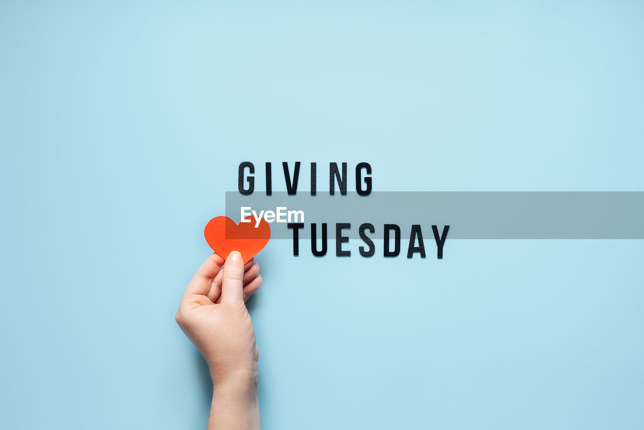 Giving tuesday, give, help, donation, support, volunteer concept with red heart in female hands and