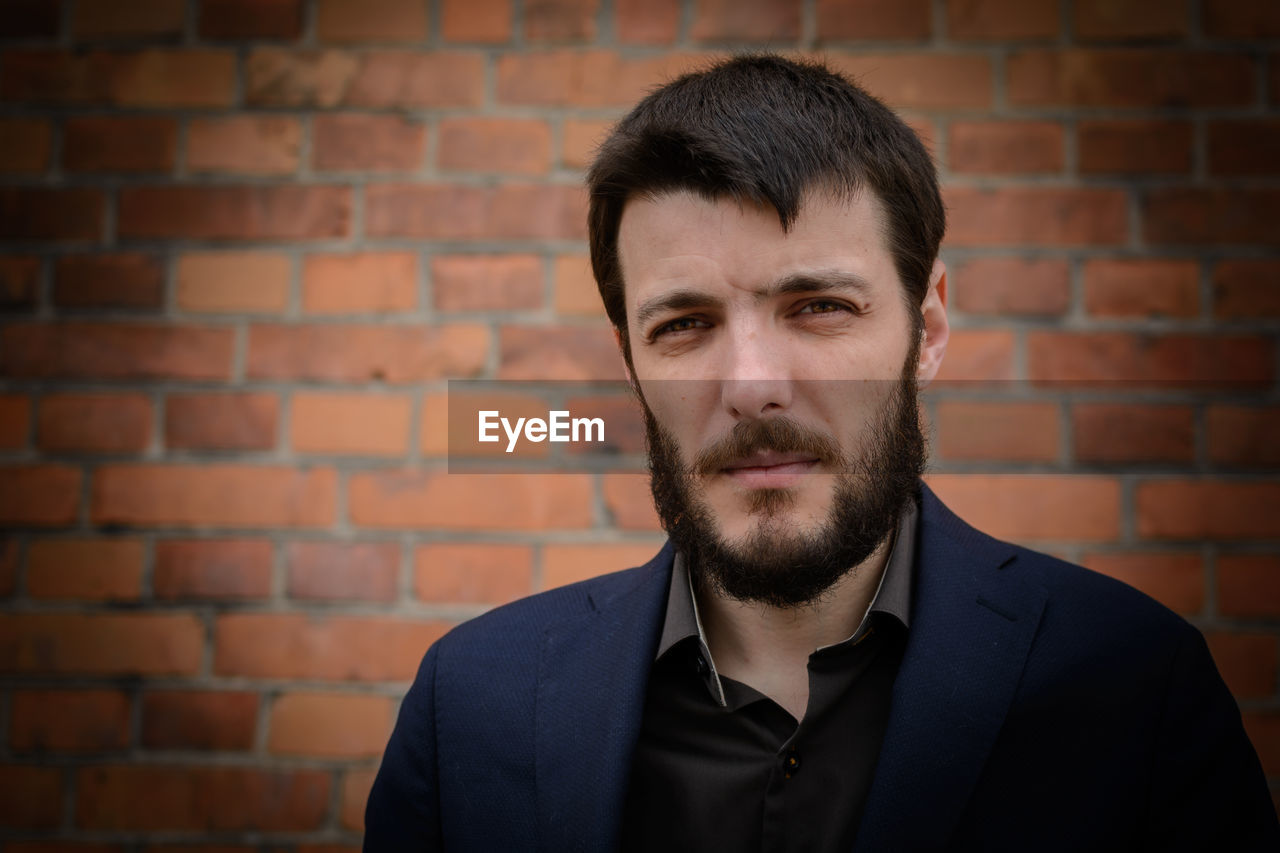 Close-up portrait of handsome young bearded man