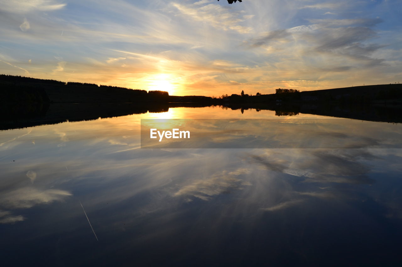Scenic view of lake against sky during sunset