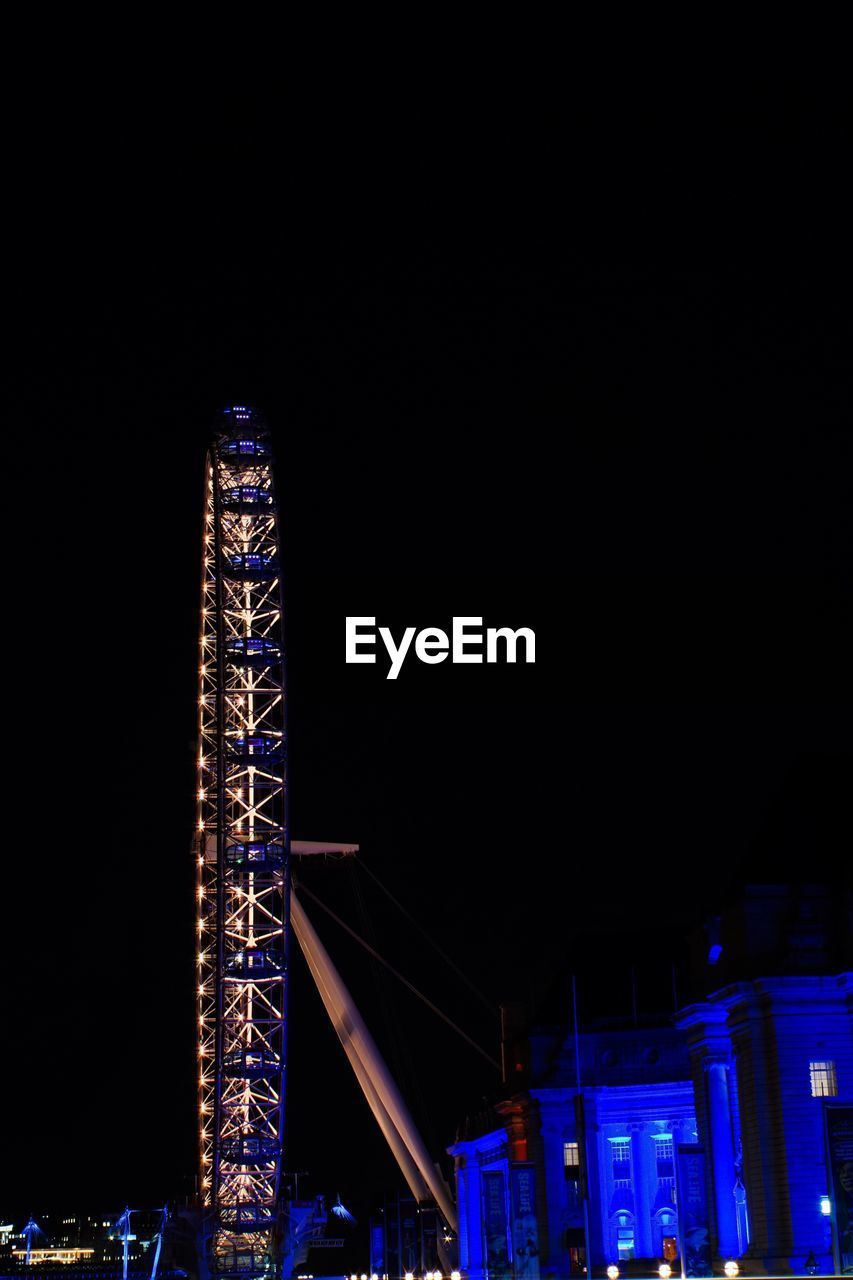 ILLUMINATED FERRIS WHEEL AT NIGHT