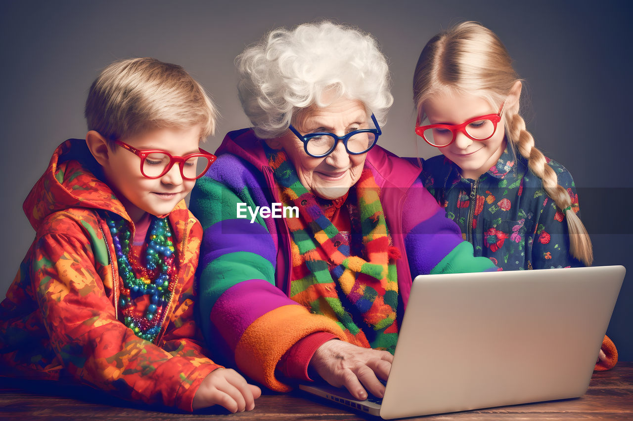 computer, laptop, wireless technology, eyeglasses, child, using laptop, glasses, technology, communication, women, childhood, female, adult, computer network, internet, family, togetherness, indoors, smiling, happiness, person, men, group of people, emotion, fun, sitting, senior adult, cheerful, human face, blond hair, using computer, seniors, portrait, positive emotion, lifestyles, small group of people, looking, human hair, clothing, vision care, relaxation