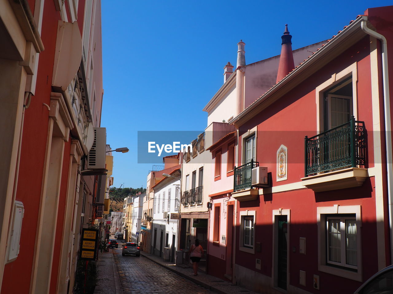 STREET AMIDST BUILDINGS AGAINST SKY