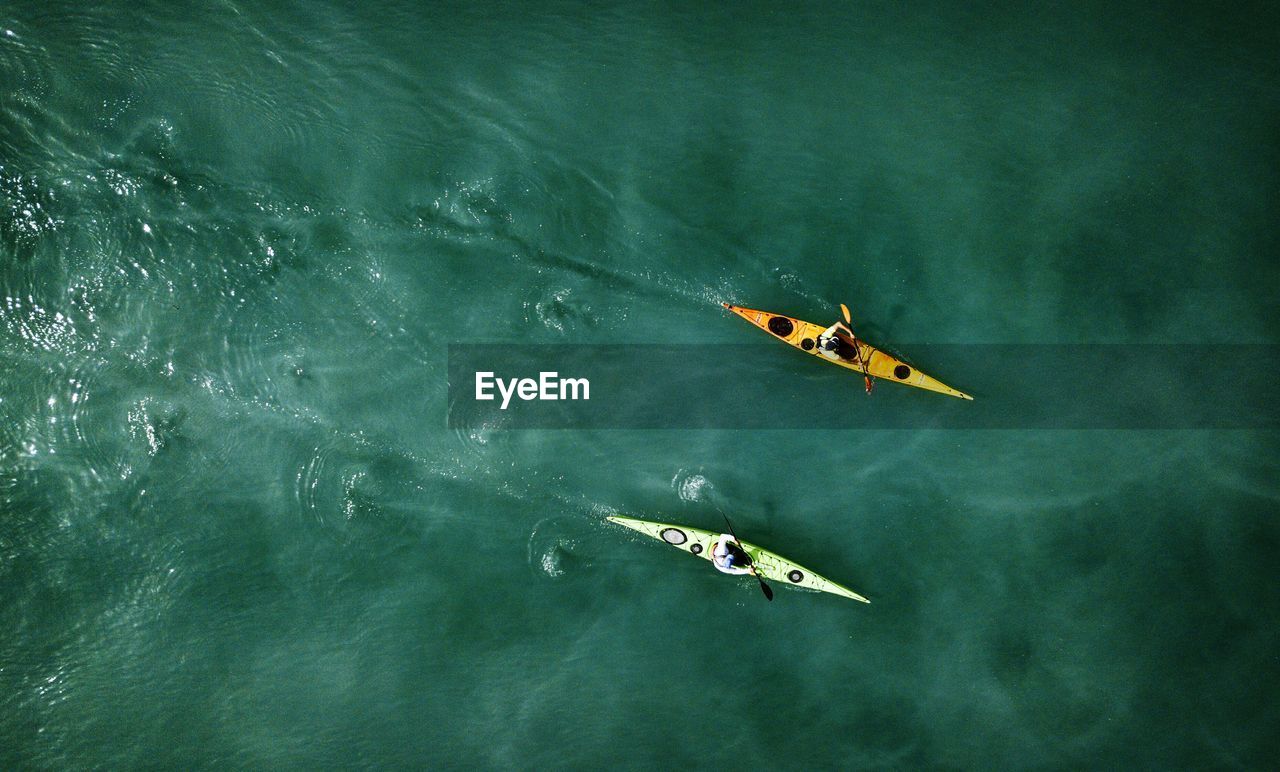 People kayaking in sea