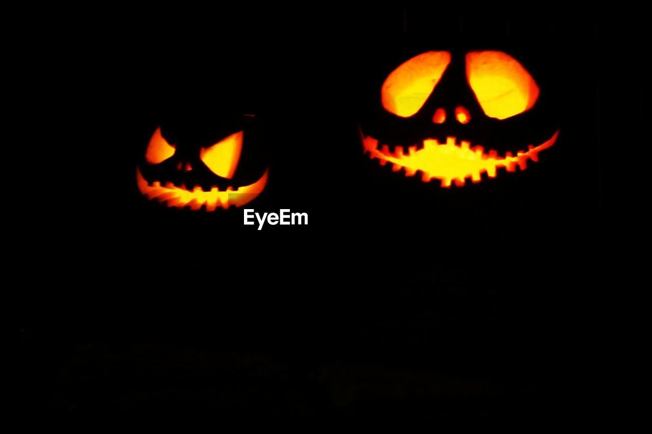 Illuminated jack-o-lanterns at night