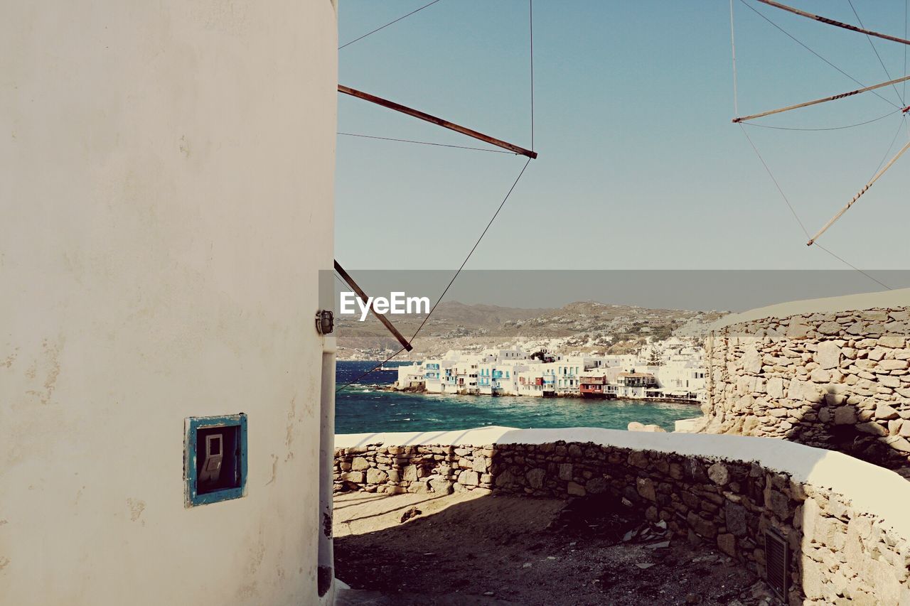 View of town by sea against clear sky