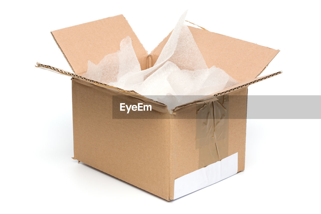 Close-up of plastic in cardboard box against white background